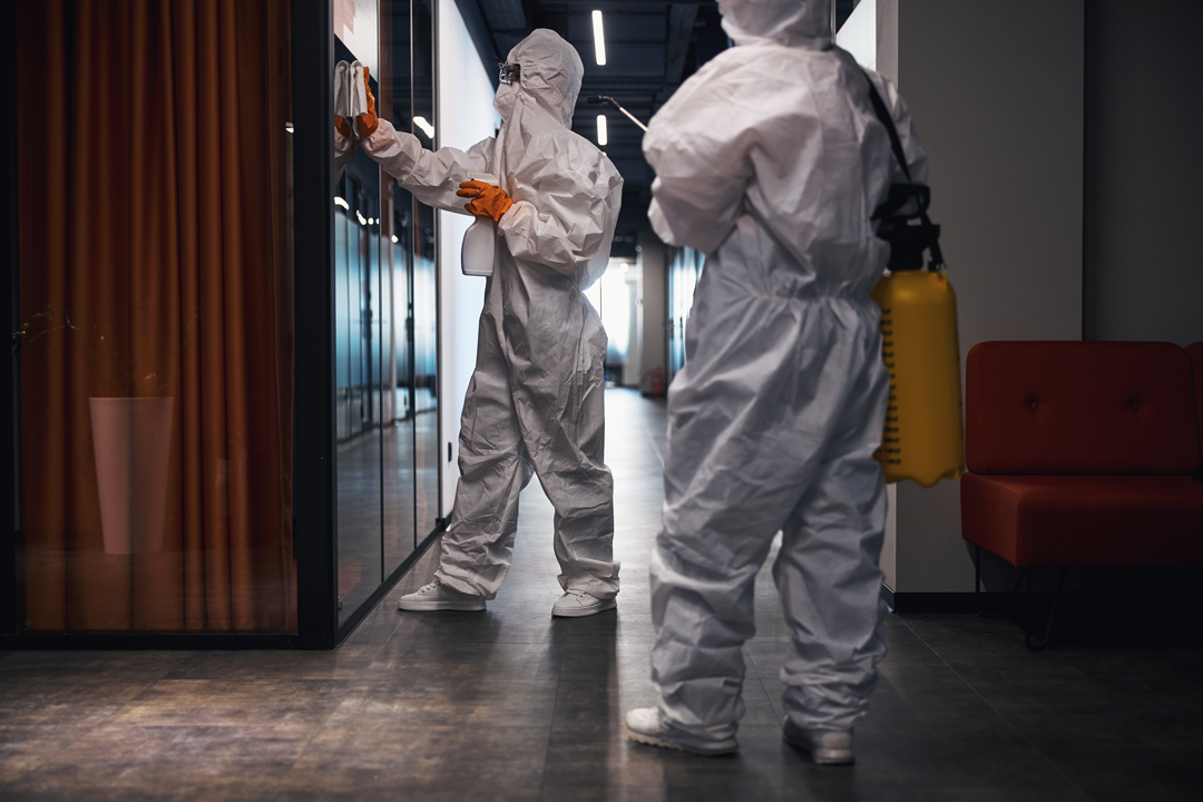 two-people-in-hazmat-suits-disinfecting-the-office-2026-01-05-23-01-29-utc